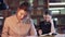 Three young students sitting in library and doing their business