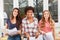 Three young women as friends smile happily