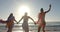 Three young women enjoy a sunny beach day