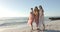 Three young women enjoy a sunny beach day