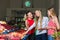 Three young women at grocery market.