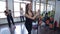 Three young women in the gym doing exercises with black bodibar.