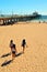 Three young women head to the ocean