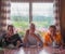 Three young women mountain climbers enjoy a hot coffee in a mountain hut after a hard climb