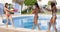 Three young women playing with colorful water guns