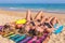 Three young women sunbathing on beach