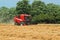 Thresher harvesting wheat