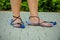 Thrifty woman wearing plastic bottle sandals