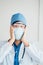 Thrilled asian doctor in medical mask and uniform