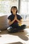 Thrilled child enjoying namaste while practicing yoga for happiness, home