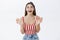 Thrilled sociable and talkative upbeat woman in striped trendy top with awesome body shaking palms joyfully and smiling