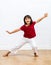 Thrilled young girl dancing, showing her smile expressing positive emotions