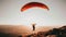 Thrilling aerial adventure man paragliding alone, soaring through the skies on a sunny day