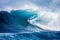 Thrilling extreme sport surfer riding gigantic blue ocean wave