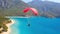 Thrilling Heights, Tandem Paraglider Dances Across the Sky Above the Idyllic Blue Lagoon and Beach. Generative AI