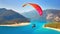 Thrilling Heights, Tandem Paraglider Dances Across the Sky Above the Idyllic Blue Lagoon and Beach. Generative AI