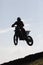 Thrilling rally bike race captures mid-air jump.