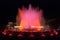 Throngs of people at the colourful light & water fountain show. Night in Barcelona, Spain, at the magic fountain.