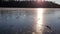 Throwing a chunk of ice that crushes on a frozen lake. Sunny winter day. Slow