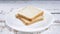 Throwing fresh slices of toast bread on white plate