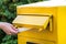 Throwing a letter in a yellow mailbox