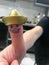 Thumb, finger Mexican in gold hat sombrero with painted cheerful cheerful face with mustaches and eyes