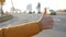 Thumb up. Close-up of a hand. Hitch-hiking. The movement of cars. Slow motion