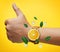 Thumb up Hand Wearing Fruit Orange Watch Green Leaves and Ice Cu