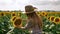 Thumb up happy farmer girl checking the sunflower