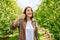 Thumb up with one hand wide smile young woman farmer looking at camera.