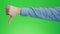 Thumbs down sign hand gesture on green screen. Simbol of disapproval dislike negative emotion.