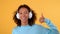 Thumbs up! close-up, female portrait, Young smiling woman in big white wireless headphones shows her thumbs up. Isolated