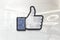 Thumbs up facebook on glossy office wall realistic texture
