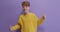 Thumbs up, nice sign. Portrait of young teen boy, student wearing yellow shirt posing