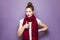 Thumbs up, young emotional girl with collected hair, freckles and red scarf looking excited with thumbs up on purple background