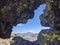 Thunder Mountain Vista  through a Gap in Lichen-Dappled Rock