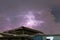 Thunderbolt over the house and dark stormy sky on the background