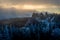 A thundercloud moving over the crest of a snow covered cliff