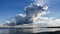 Thundercloud over Pumicestone Passage from Bribie Island in Queensland Australia looking over water toward the Glasshouse mountain