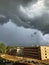 Thunderclouds over a city courtyard.