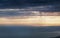 Thunderclouds over the sea at sunset disappearing into the horizon