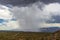 Thunderhead cloud produces rain shower over semi-desert grassland prairie