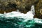 Thundering blue-green surf crashes against the rugged Cliffs of Kilkee, Loop Head Peninsula, County Clare, Ireland.