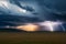 A thunderstorm is coming in the fields of South Africa. The storm is coming