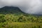 Thunderstorm dark cloud hanging over the mountain and the jungle