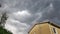 Thunderstorm with dark threatening clouds above a building