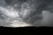 Thunderstorm with heavy rains flying over the dark prairie.