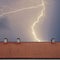 Thunderstorm with lightening over the roof at night.