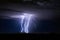 Thunderstorm with lightning bolt strikes and storm clouds over a city