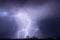 Thunderstorm and lightning bolts striking at night